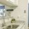 sink with granite countertops and white kitchen cabinets